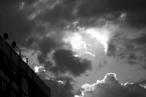 Dramatic storm clouds gathering in a moody grey sky